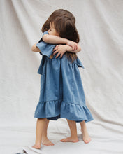 Load image into Gallery viewer, Girl Denim dress with ruffle edged hem and ruffle shoulders details.