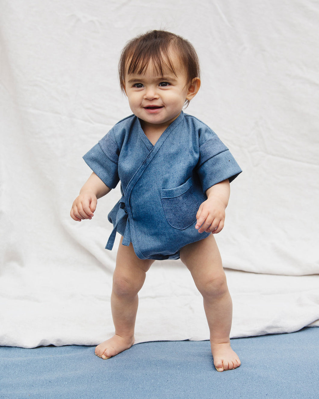 Premium Upcycled Denim Pocket Kimono Onesie for babies with a pocket detail.